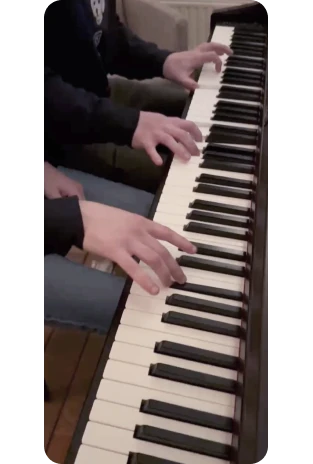 Hands playing piano backstage